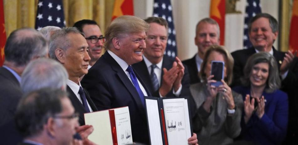 Donald Trump presentando el acuerdo comercial firmado con China. / AP