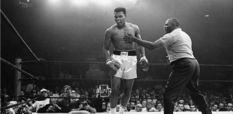 Muhammad Ali parado sobre su oponente Sonny Liston, en una de sus legendarias peleas. Foto: The Jot Down.