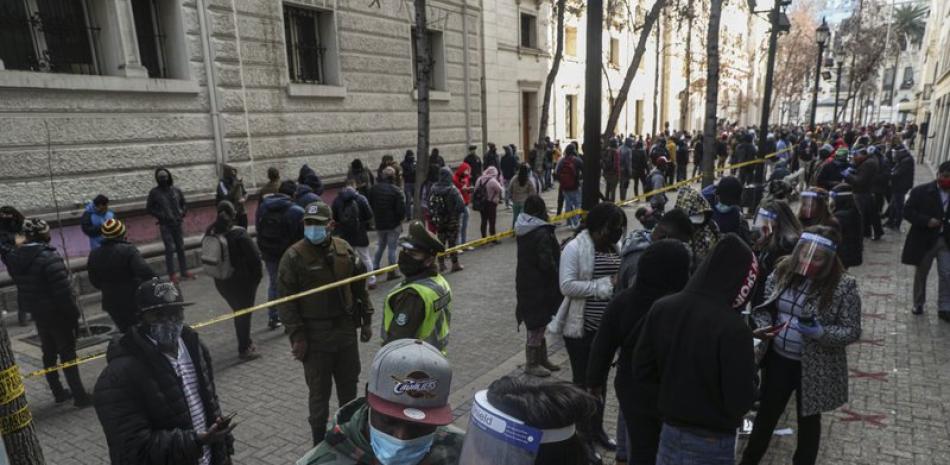 Cientos de personas forma una fila para obtener un porcentaje de sus fondos de ahorro para el retiro, en esta fotografía de archivo del jueves 30 de julio de 2020, en Santiago de Chile. (AP Foto/Esteban Felix)
