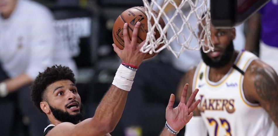 El escolta de los Denver Nuggets, Jamal Murray, a la izquierda, se levanta para un intento de tiro mientras LeBron James, de Los Angeles Lakers, detrás de la derecha, observa durante la segunda mitad del Juego 3 de la final de la Conferencia Oeste de baloncesto de la NBA.