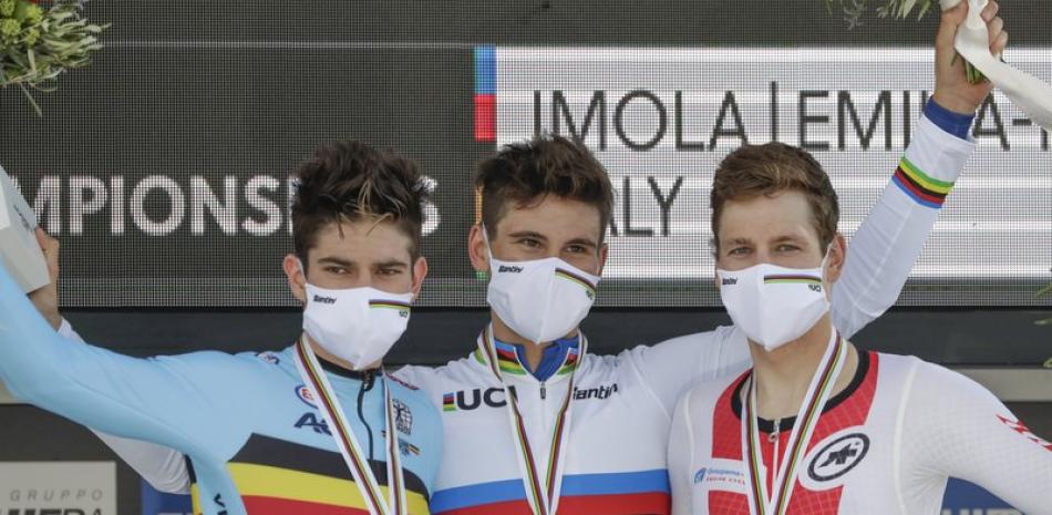 El italiano Filippo Ganna, centro, ganador de la prueba contrarreloj del mundial de ciclismo de ruta, posa en el podio con el belga Wout van Aert, izquierda, quien terminó en el segundo lugar, y el suizo Stefan Kung, tercero, en Imola, Italia.