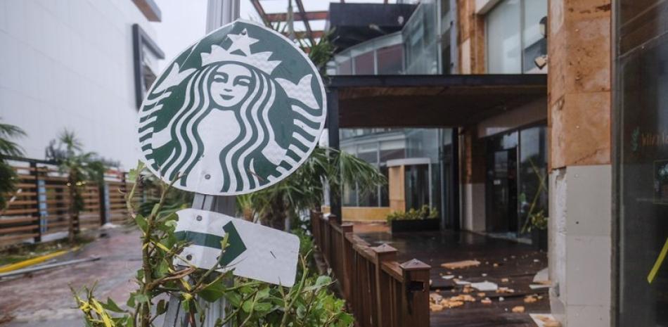 Esta fotografía del miércoles 7 de octubre de 2020 muestra el letrero de una cafetería Starbucks y otros objetos dañados por el huracán Delta en Cancún, México. (AP Foto/Víctor Ruiz García)
