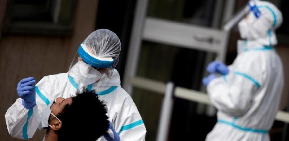 Un hombre se somete a una prueba de hisopo para detectar el coronavirus en un sitio de pruebas de manejo del hospital italiano. Foto: Tiziana Fabi/AFP.