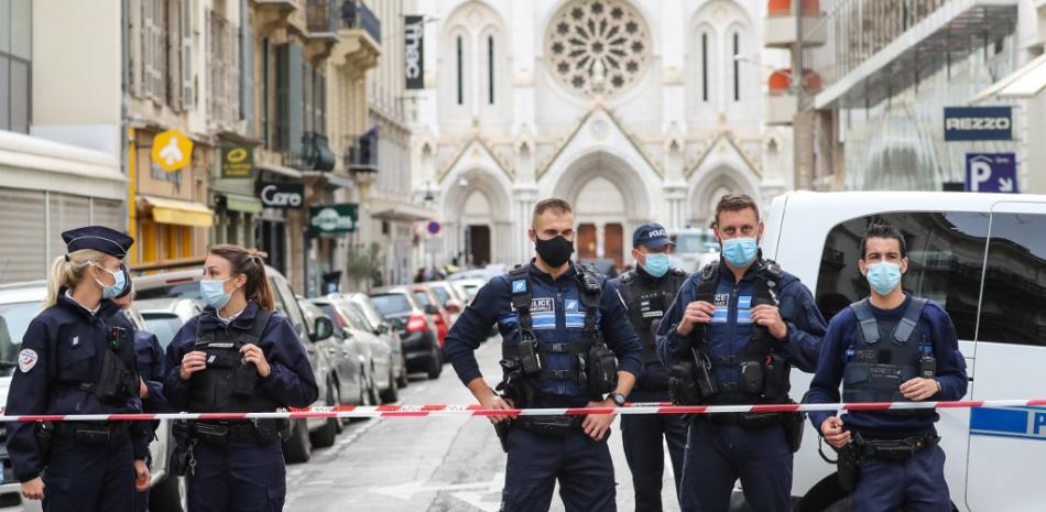 La policía bloquea el acceso a la Basílica de Notre-Dame de l'Assomption en Niza después de que un hombre con un cuchillo matara a tres personas en la iglesia, degollando al menos a una de ellas. Valery Hache / AFP