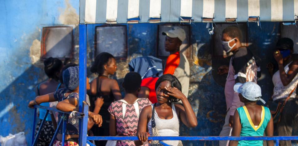 Lina André busca a su novio en la entrada de la Penitenciaría Nacional de Puerto Príncipe, Haití, para entregarle comida el 25 de enero del 2021.

Foto: AP/ Dieu Nalio Chery