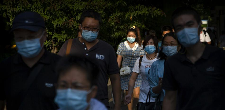 Peatones, con mascarilla para protegerse del coronavirus, pasean por una calle en un distrito comercial del centro de Beijing, el 2 de septiembre de 2020.

Foto: AP/ Mark Schiefelbein