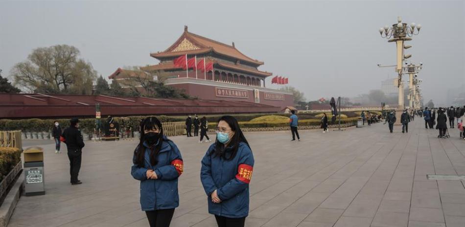 Voluntarios de seguridad pública patrullan frente a la Torre de la Puerta de Tiananmen en Pekín, China. EFE/EPA/STRINGER