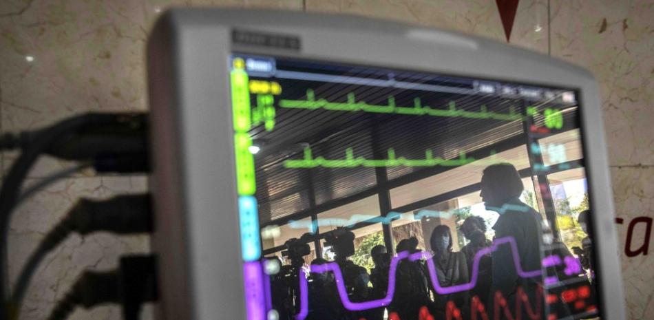 Los periodistas se reflejan en la pantalla de un monitor cardíaco desarrollado por la industria científica cubana, durante una conferencia de prensa en La Habana, Cuba, el miércoles 31 de marzo de 2021. (AP Foto/Ramon Espinosa)