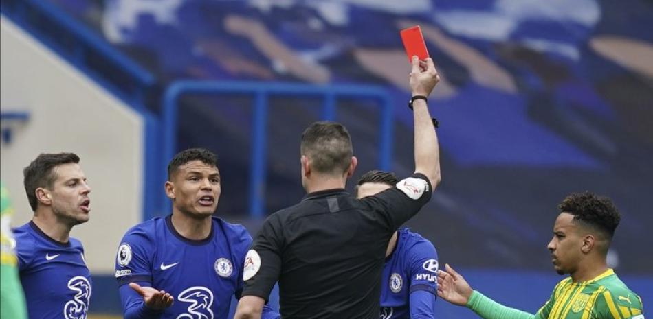 El árbitro David Coote muestra la tarjeta roja al brasileño Thiago Silva, del Chelsea, durante el partido de Chelsea contra West Bromwich Albion en el estadio Stamford Bridge en Londres, Inglaterra, sábado 3 de abril de 2021. West Brom, que está al borde del descenso, venció a Chelsea 5-2.