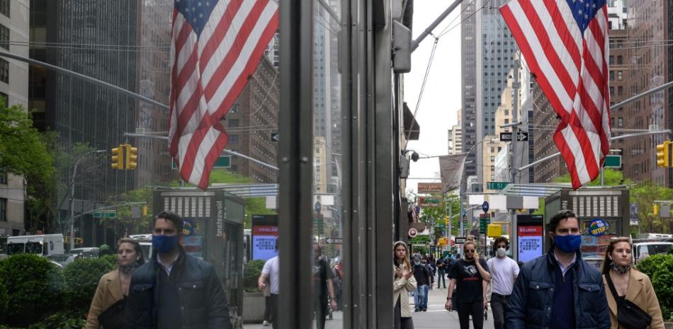 La gente pasa por edificios de oficinas en el centro de Manhattan el 7 de mayo de 2021 en la ciudad de Nueva York.  Angela Weiss / AFP