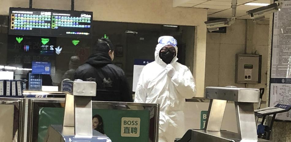 Un agente de seguridad viste un traje de seguridad en una estación de metro en Beijing, el 24 de enero de 2020.

Foto: AP / Yanan Wang
