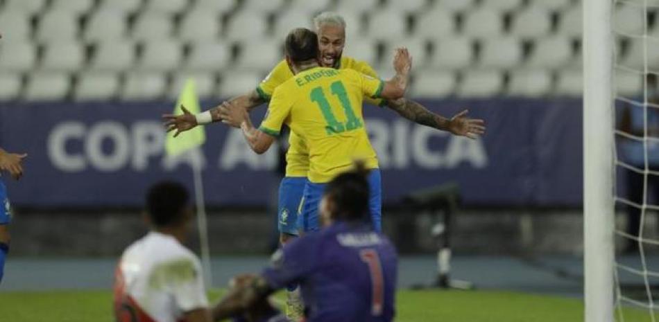 Everton Ribeiro (11) festeja con Neymar, su compañero en la selección de Brasil, luego de conseguir el tercer tanto de Brasil ante Perú en un partido de la Copa América.