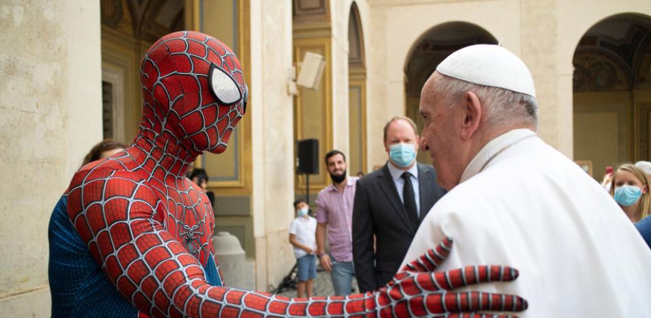 El Papa Francisco estrechando la mano de un hombre vestido con un traje del personaje de fantasía de Spider-Man. Vatican Media a través de AFP / Getty Images