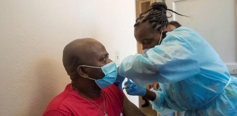 Una enfermera coloca una vacuna contra la Covid-19 a una persona hoy, en Puerto Príncipe (Haití). Haití es uno de los pocos países del mundo que no habían comenzado la vacunación contra la covid-19.. El miércoles pasado llegó al país el primer lote de 500.000 dosis de vacunas, donadas por Estados Unidos a través del mecanismo Covax, para el reparto equitativo de las dosis en países de escasos recursos, y son del laboratorio Moderna. EFE/ Orlando Barría