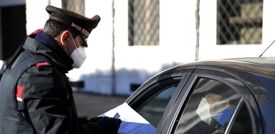 Un agente de los carabinieri comprueba documentos en un control de acceso en Roma, el lunes 15 de marzo de 2021.

Foto: Cecilia Fabiano/LaPresse via AP