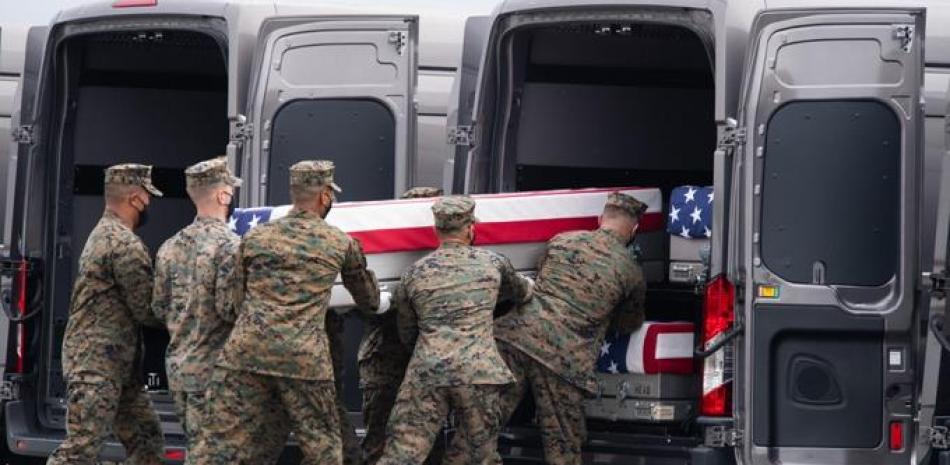 Una caja de transferencia cubierta con una bandera con los restos de un miembro del servicio caído se coloca dentro de un vehículo de transferencia mientras el presidente de los Estados Unidos, Joe Biden, asiste a la ceremonia de transferencia digna en la Base de la Fuerza Aérea de Dover en Dover, Delaware, el 29 de agosto de 2021, uno de los 13 miembros del ejército estadounidense muertos en Afganistán la semana pasada.

Foto: SAUL LOEB / AFP