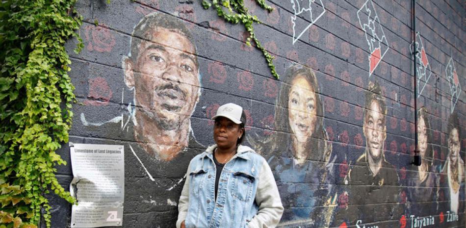 Seditra Brown stands next to a mural depicting her son Paris Brown in the US capital on Sept. 9, 2021. (Photo by Agnes Bun / AFP)