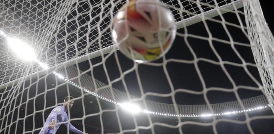 El zaguero del Barcelona Gerard Piqué se voltea tras el gol de Luis Suárez para el Atlético de Madrid por la Liga española, el sábado 2 de octubre de 2021.