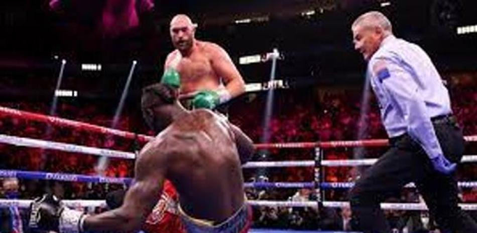 Tyson Fury al momento de derribar a Deontay Wilder durante su emocionante combate este sábado de los pesos pesados.