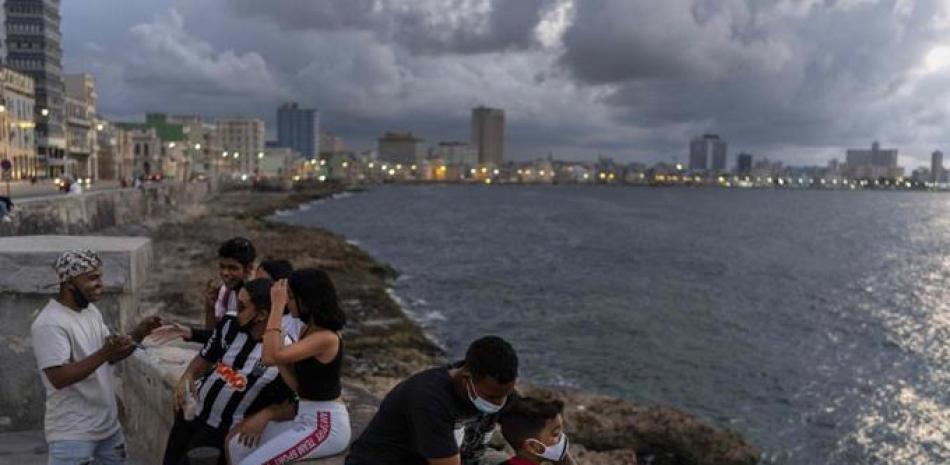 La gente pasa la tarde en el Malecón de La Habana, Cuba, el miércoles 29 de septiembre de 2021. Las autoridades de Cuba han comenzado a relajar las restricciones de COVID en varias ciudades como La Habana. (AP Foto/Ramon Espinosa)