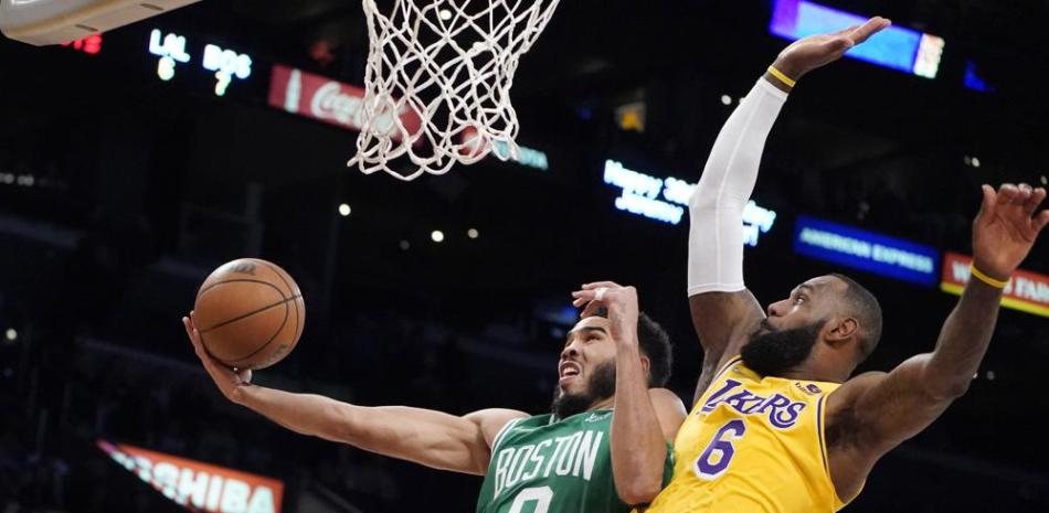 El jugador de los Celtics de Boston Jayson Tatum (0) tira a canasta mientras el jugador de los Lakers de Los Ángeles LeBron James (con el 6) defiende en la primera mitad de su juego de NBA el martes 7 de diciembre de 2021, en Los Ángeles.