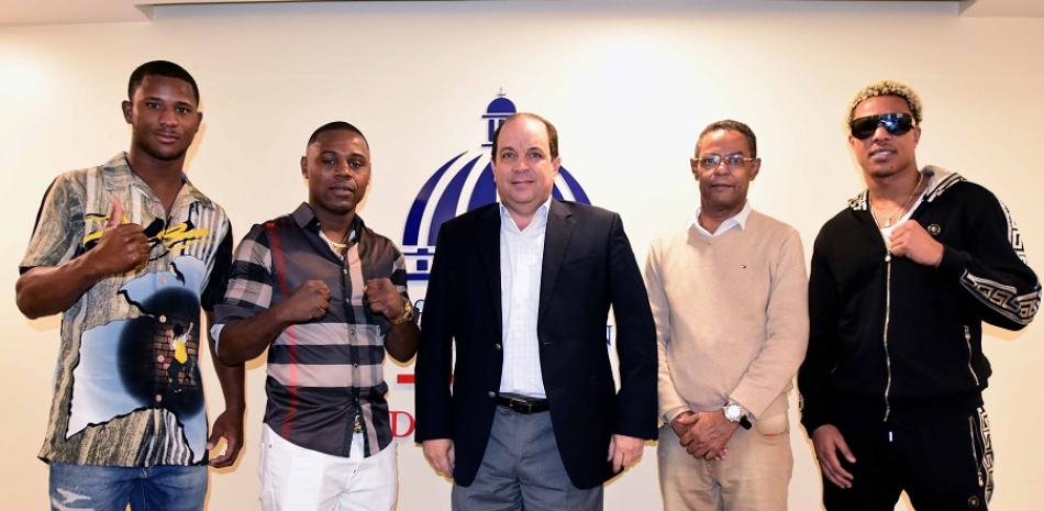 El promotor César Mercedes, el viceministro de Deportes, Franklin de la Mota, junto a parte de los boxeadores que actuarán en la cartelera 100 de la empresa Manguita Boxing Promotion.