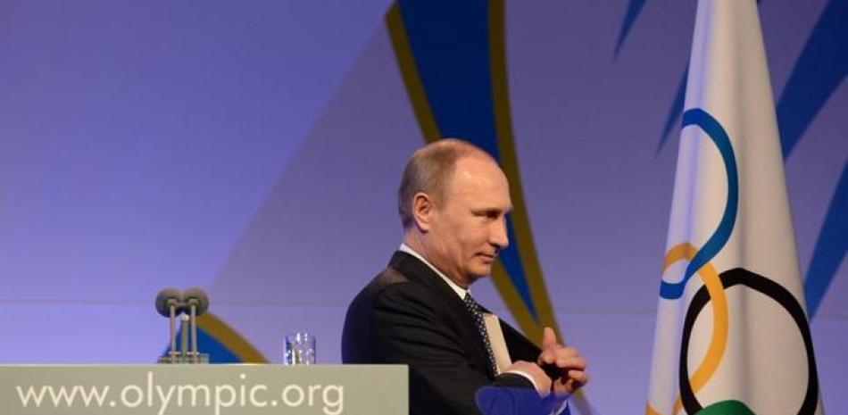 El presidente ruso, Vladimir Putin, deja el escenario después de su discurso en la cena de gala del Comité Olímpico Internacional (COI) el 6 de febrero de 2014 en Sochi, en la víspera de la ceremonia de apertura de los Juegos Olímpicos de Invierno de Sochi 2014.
ANDREJ ISAKOVIC / PISCINA / AFP