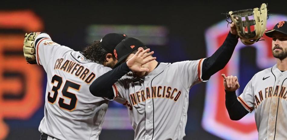 San Francisco Giants right fielder Mike Yastrzemski, right, and Brandon Crawford celebrate after the Giants defeated the Guardians 4-2 in a baseball game, Saturday, April 16, 2022, in Cleveland. (AP Photo/David Dermer)