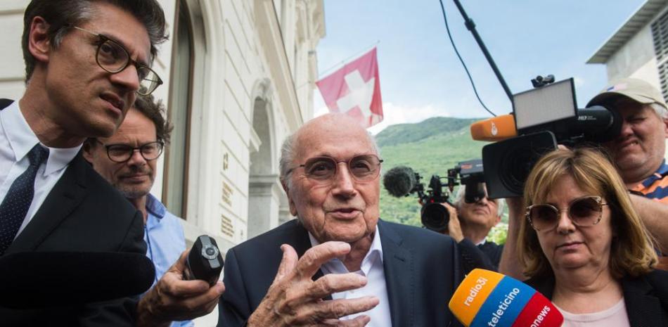 El ex presidente de la FIFA Joseph Blatter es rodeado por la prensa al salir del tribunal federal en Bellinzona, Suiza.