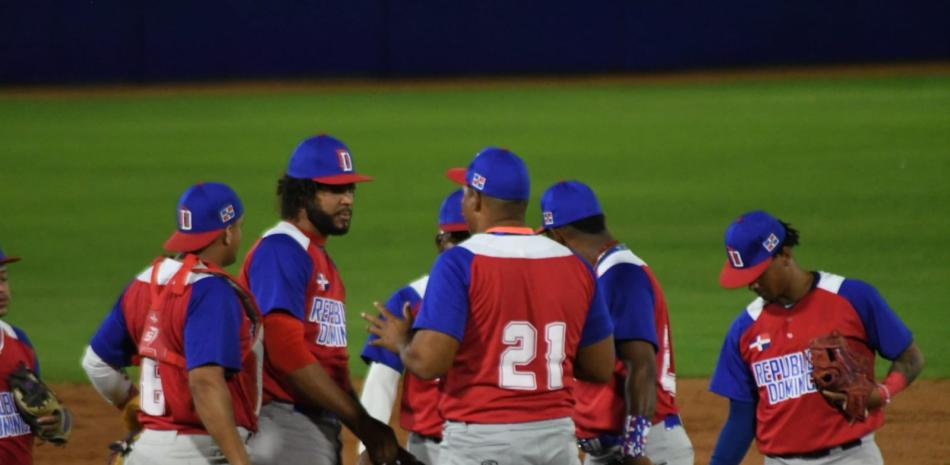 El dirigente Rafael García (21) y los jugadores del cuadro interior conversan con el lanzador Samuel Burgos.