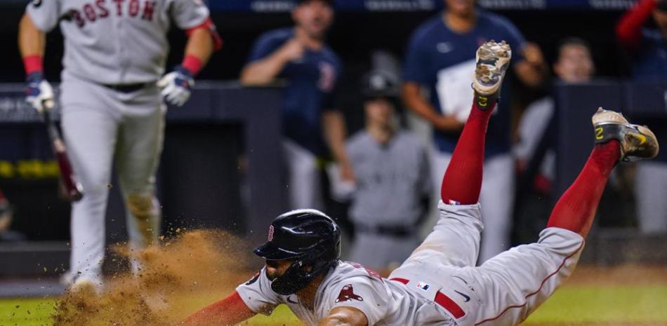 Xander Bogaerts, de los Medias Rojas de Boston, anota de barrida tras un lanzamiento descontrolado del relevista Michael King, de los Yanquis de Nueva York.