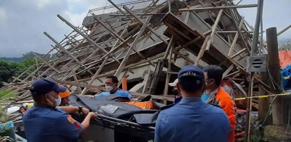 Un equipo de rescate moviendo el cuerpo de un trabajador en un edificio derrumbado en Filipinas. Foto de AFP Forum.