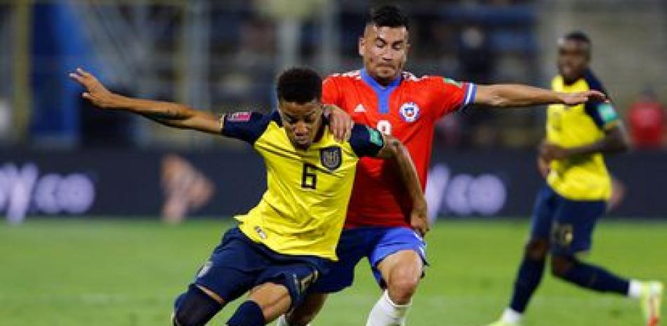 Un jugador de Chile persigue a un oponente de Ecuador en uno de los partidos clasificatorios