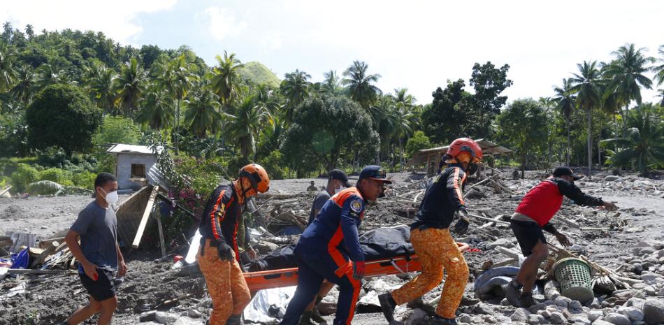 Rescatistas cargan un cuerpo el domingo 30 de octubre de 2022, en la localidad de Datu Odin Sinsuat, en la provincia de Maguindánao, Filipinas. (AP Foto)