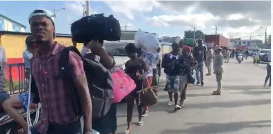 Cientos de ilegales haitianos arrestados en territorio dominicano forman una extensa fila en un punto de la frontera rumbo a Haití, tras ser repatriados por Migración. / Archivo