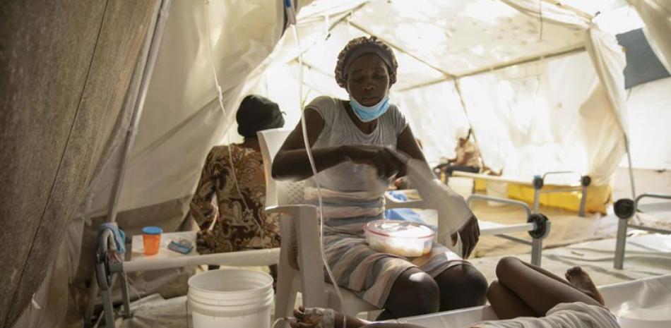 Una mujer usa una toalla para espantar las moscas de su hija enferma de cólera, en una clínica de Médicos Sin Fronteras en la capital, el 11 de noviembre de 2022. AP