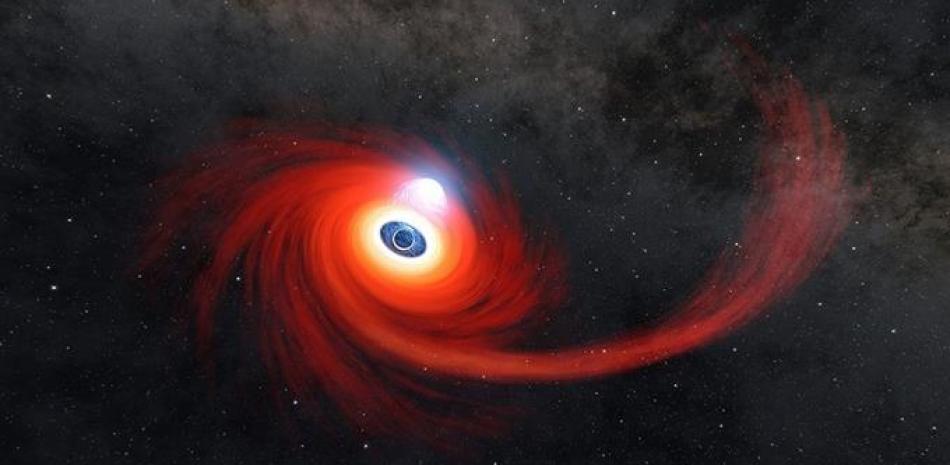 En esta ilustración, un disco de gas caliente se arremolina alrededor de un agujero negro. La corriente de gas que se extiende hacia la derecha es lo que queda de una estrella que fue desintegrada por el agujero negro. Foto: Europa Press