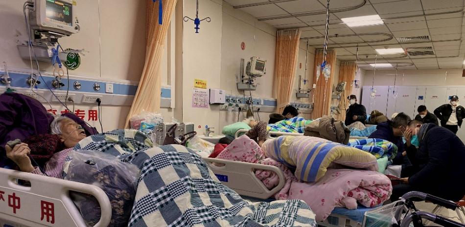 Pacientes con Covid-19 yacen en camas del Hospital Tangshan Gongren, en la ciudad nororiental china de Tangshan, el 30 de diciembre de 2022. Fuente: AFP.