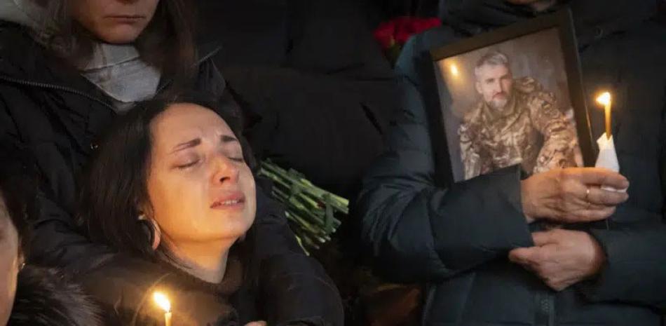Familiares de Volodymyr Yezhov, en su funeral en la catedral de San Volodymyr, en Kiev, Ucrania, el martes 27 de diciembre de 2022. AP