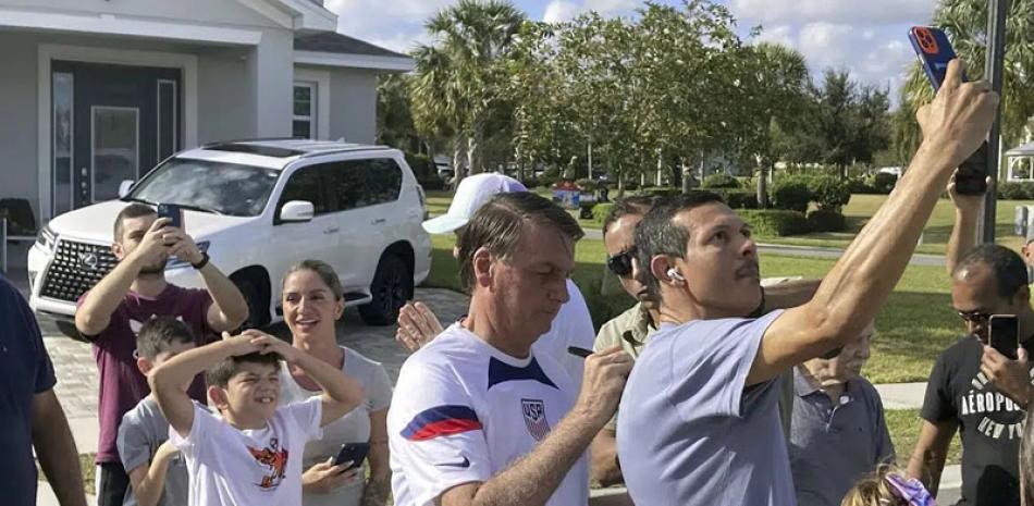 El expresidente de Brasil, Jair Bolsonaro, centro, se reúne con simpatizantes frente a una casa veraniega cerca de Orlando, Florida, el 4 de enero de 2023. AP