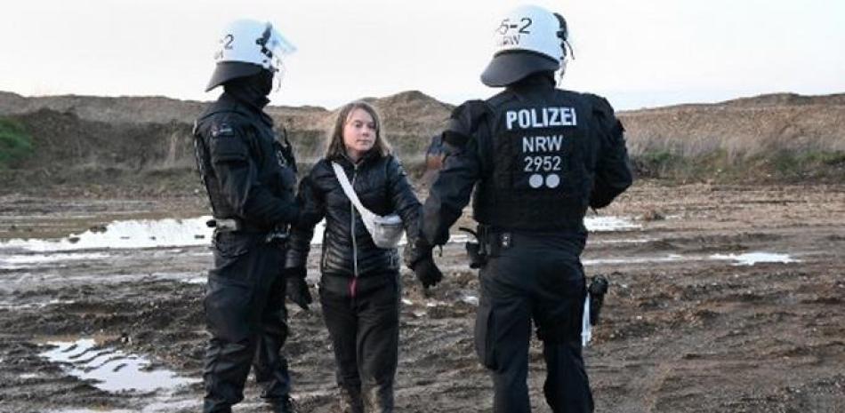Los agentes de policía separan a la activista climática sueca Greta Thunberg (C) de un grupo de manifestantes y activistas en Erkelenz, Alemania occidental, el 17 de enero de 2023, mientras continúan las manifestaciones contra la extensión de una mina de carbón en el pueblo cercano de Luetzerath.
