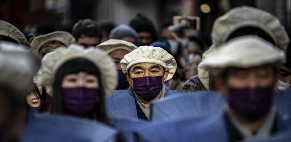 Personas con mascarillas para protegerse del coronavirus en el distrito comercial de Shimokitazawa, en Tokio, el 28 de enero de 2023. Fuente: AFP.