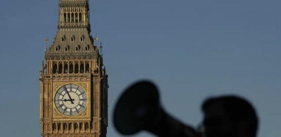 Un manifestante con un megáfono corea lemas ante el Big Ben, durante una protesta de enfermeras del cercano Hospital St. Thomas en Londres, el lunes 6 de febrero de 2023. (Foto AP/Frank Augstein)