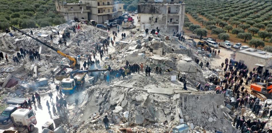 Esta vista aérea muestra a los residentes, ayudados por equipos pesados, buscando víctimas y sobrevivientes entre los escombros de los edificios derrumbados luego de un terremoto en la aldea de Besnia, cerca de la ciudad de Harim, en la provincia noroccidental de Idlib en Siria, controlada por los rebeldes, en la frontera con Turquía. el 6 de febrero de 2022.
Foto: Omar Hajkadour| AFP