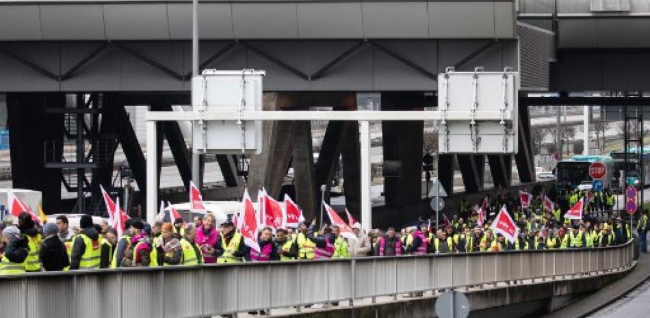 Manifestantes y miembros del sindicato ver.di se manifiestan mientras organizan una huelga en el aeropuerto de Frankfurt am Main, Alemania occidental, el 17 de febrero de 2023. AFP