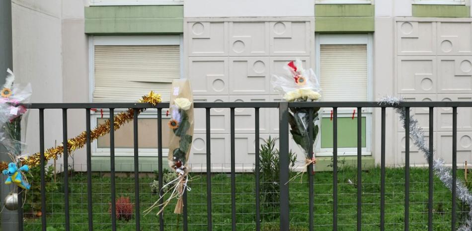 Esta fotografía muestra ramos de flores en la valla justo delante del apartamento donde se descubrieron los cuerpos de una mujer y sus cuatro hijos, en Meaux, al este de París