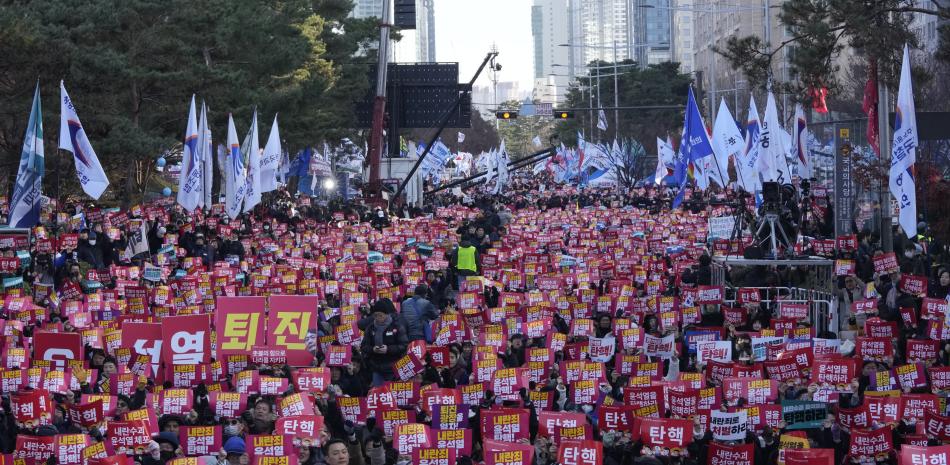 Manifestantes muestran pancartas con la frase "juicio político Yoon Suk Yeol"