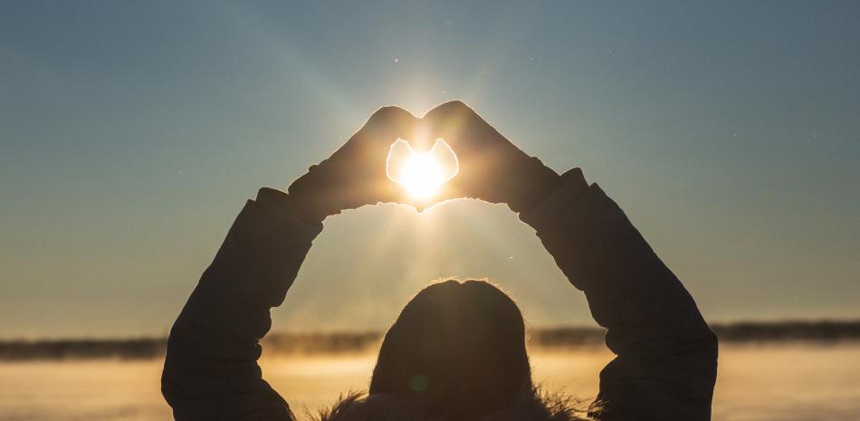 Mujer de espaldas formando el símbolo del corazón con sus manos. Foto: Sergey Zaykov-Shutterstock,  facilitada por Rant Casino/Journalistic.