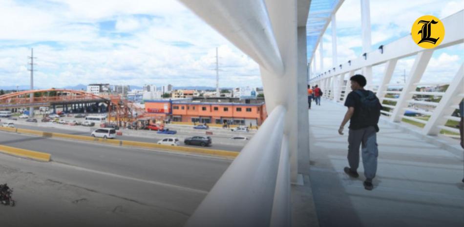 Personas cruzan el nuevo puente del kilómetro 9 de la autopista Duarte