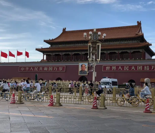 Residentes pasan frente a una camioneta de la policía estacionada junto a la Puerta de Tiananmen, en Pekín, ayer.